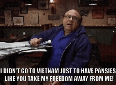 Shirtless Man Sitting In Field Hands On Stomach GIF