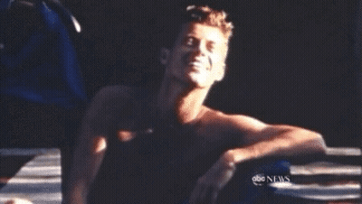 Shirtless Man Sitting In Front Of ABC News Screen GIF