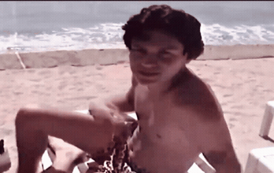 Shirtless Man Sitting On Beach Chair GIF
