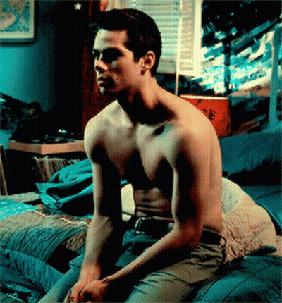 Shirtless Man Sitting on Bed Hands on Knees