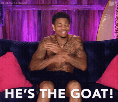 Shirtless Man Sitting On Couch He's The Goat GIF