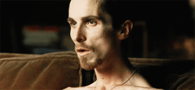 Shirtless Man Sitting On Couch With Mouth Open GIF