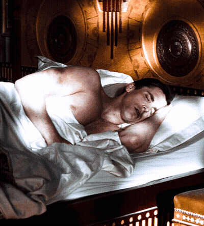 Shirtless Man Sleeping In Bed With Clock GIF