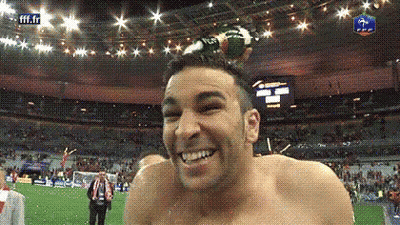 Shirtless Man Smiling As Soccer Ball Flies Overhead GIF