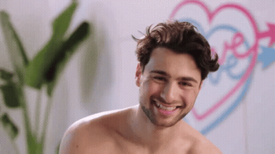 Shirtless Man Smiling At Pink And Blue Heart With Love GIF