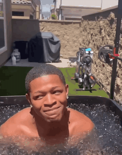 Shirtless Man Smiling In Water Tub GIF