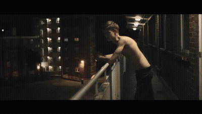 Shirtless Man Smoking Cigarette In The Dark GIF