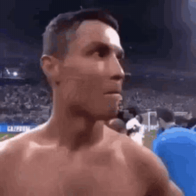 Shirtless Man Standing Before Crowd GIF