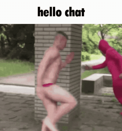 Shirtless Man Standing By Brick Wall Saying Hello Chat GIF