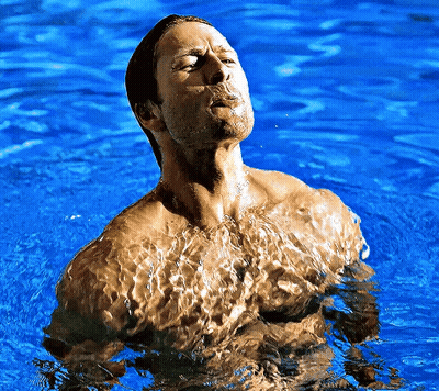 Shirtless Man Standing In Blue Water GIF