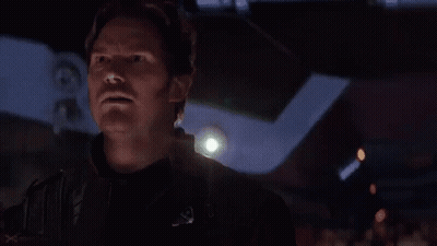 Shirtless Man Standing In Dark Room GIF