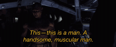 Shirtless Man Standing In Dark Room Saying This Is A Man GIF