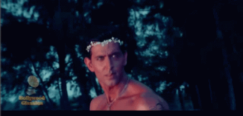Shirtless Man Standing In Forest With Bollywood Classics Logo GIF