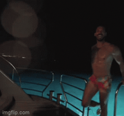 Shirtless Man Standing In Front Of Dom Sign GIF