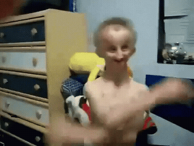 Shirtless Man Standing In Front Of Dresser GIF
