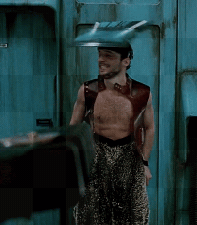 Shirtless Man Standing In Front Of Emergency Exit Door GIF