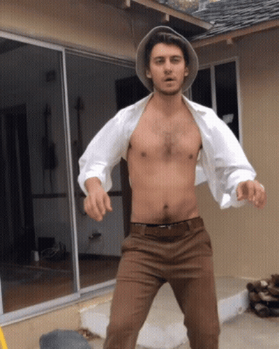 Shirtless Man Standing In Front Of House GIF