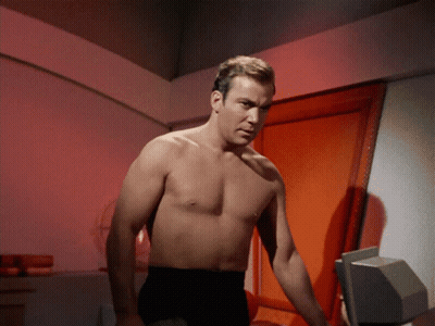 Shirtless Man Standing In Front Of Red Door GIF