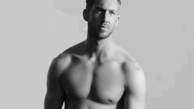 Shirtless Man Standing In Front Of White Wall GIF