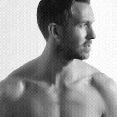 Shirtless Man Standing In Front Of White Wall GIF