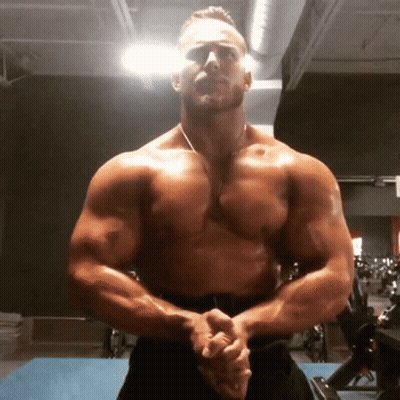 Shirtless Man Standing In Gym With Arms Crossed GIF