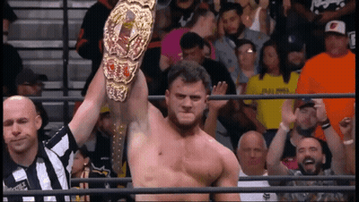 Shirtless Man Standing In Ring With Arms Outstretched GIF