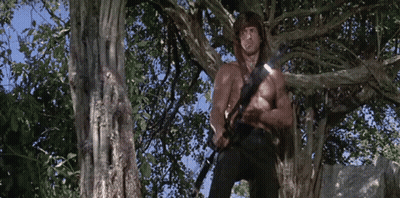Shirtless Man Standing In Tree With Sword GIF