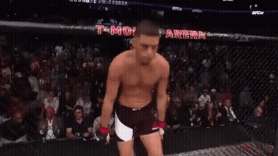 Shirtless Man Standing In UFC Cage GIF