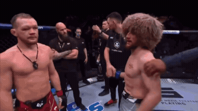 Shirtless Man Standing Next To Man In Boxing Ring GIF