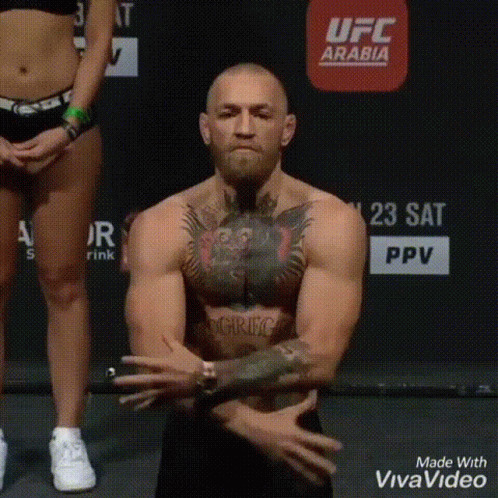 Shirtless Man Standing On Scale Hands Folded GIF
