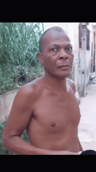 Shirtless Man Standing On Sidewalk GIF