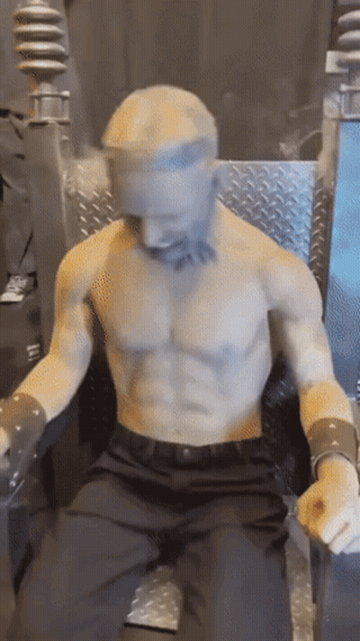 Shirtless Man Statue Sitting In Chair GIF