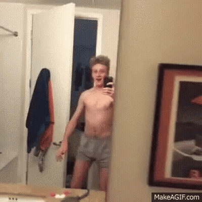 Shirtless Man Taking Selfie In Mirror GIF