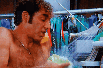 Shirtless Man Taking Shower Holding Sponge GIF
