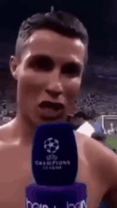 Shirtless Man Talking Into Champions League Microphone GIF