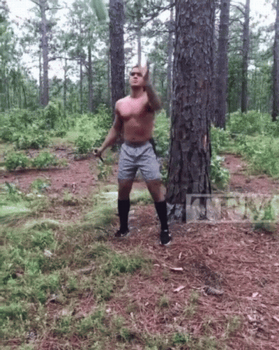 Shirtless Man Throwing Frisbee In Forest GIF