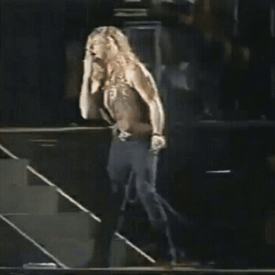 Shirtless Man Walking Down Stairs On Stage Holding Microphone GIF