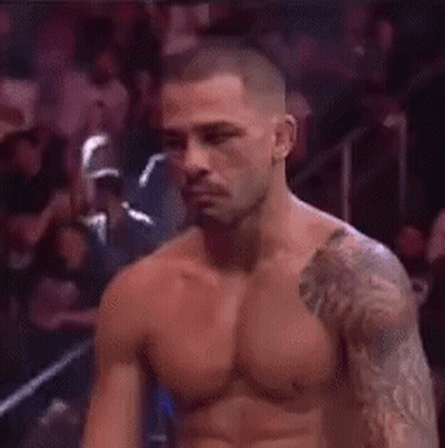 Shirtless Man With Arm Tattoo In Boxing Ring GIF