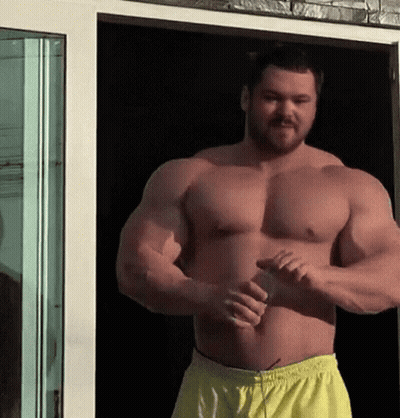 Shirtless Man With Beard By Glass Door GIF