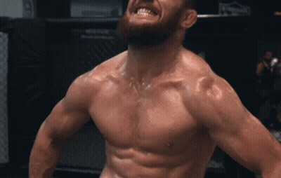 Shirtless Man With Beard In Front Of UFC Sign GIF
