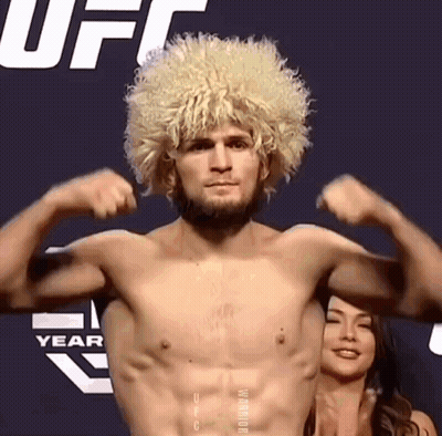 Shirtless Man With Blonde Wig Flexing GIF