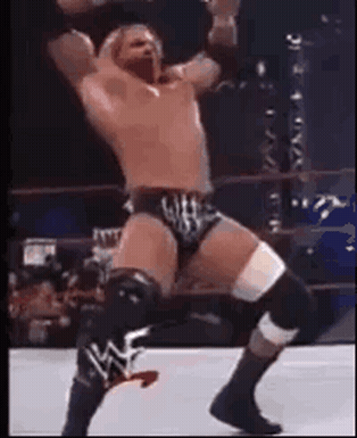 Shirtless Man With Chest Tattoo And Chain Looking Up GIF
