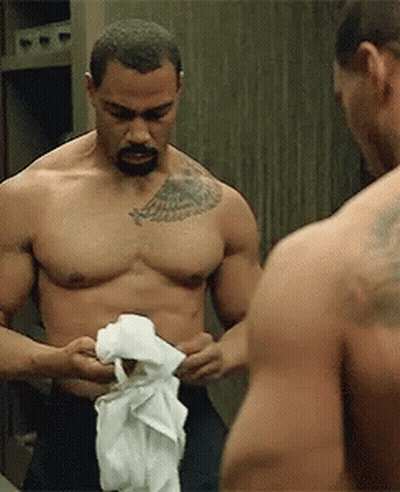Shirtless Man With Chest Tattoo Looking At Mirror Reflection GIF
