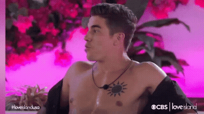 Shirtless Man With Chest Tattoo Sitting In Chair GIF