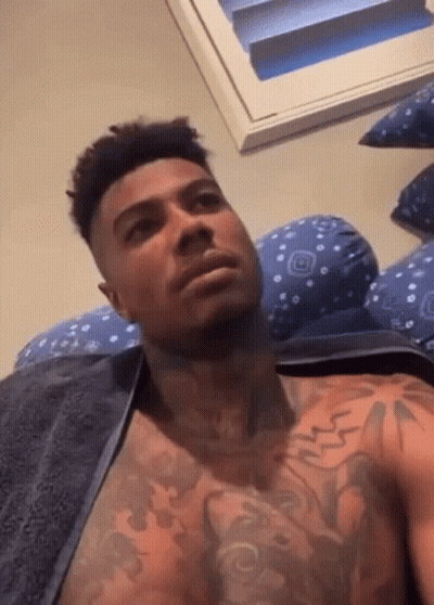 Shirtless Man With Chest Tattoos Laying On Bed With Towel GIF