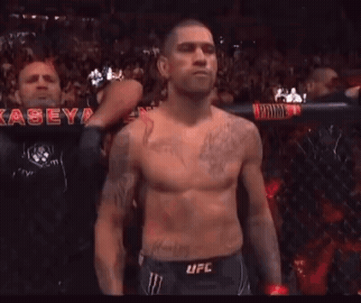 Shirtless Man With Dragon Tattoo Standing Before Crowd GIF