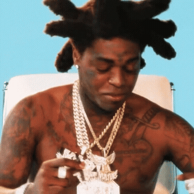 Shirtless Man With Dreadlocks Holding Paper GIF