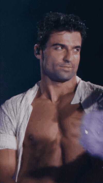 Shirtless Man With Ear Buds Looking At Something GIF