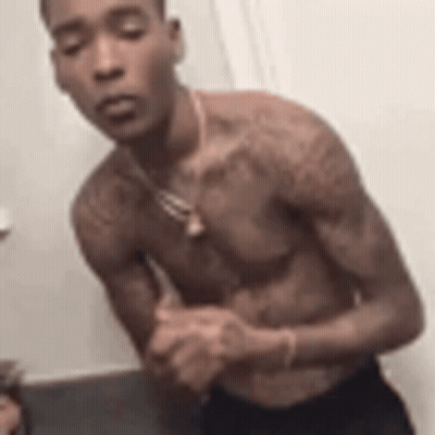 Shirtless Man With Folded Hands In Bathroom GIF