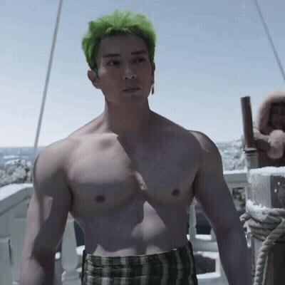 Shirtless Man With Green Hair And Plaid Shorts On Balcony GIF